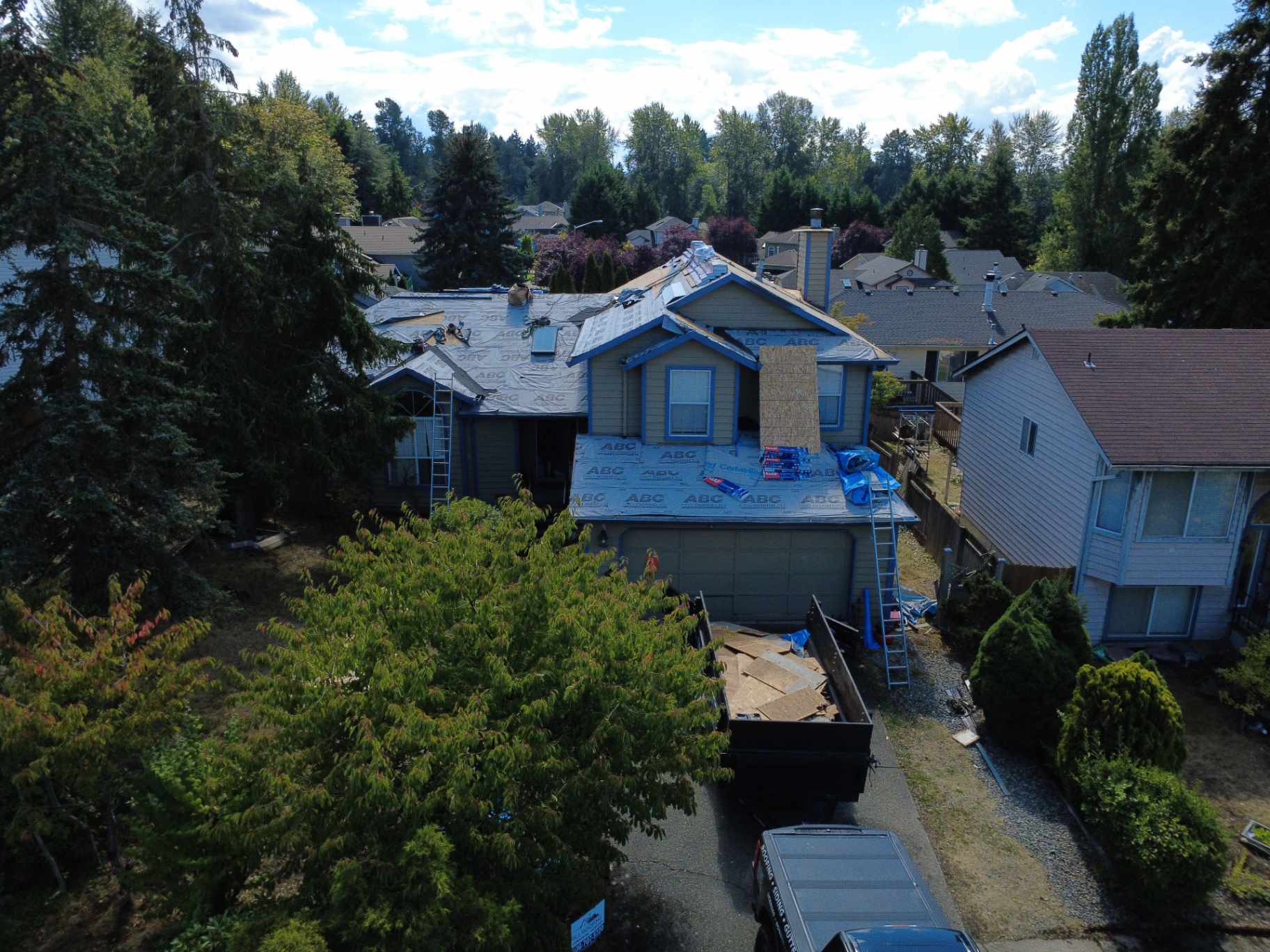 Residential roof replacement in progress with underlayment installed