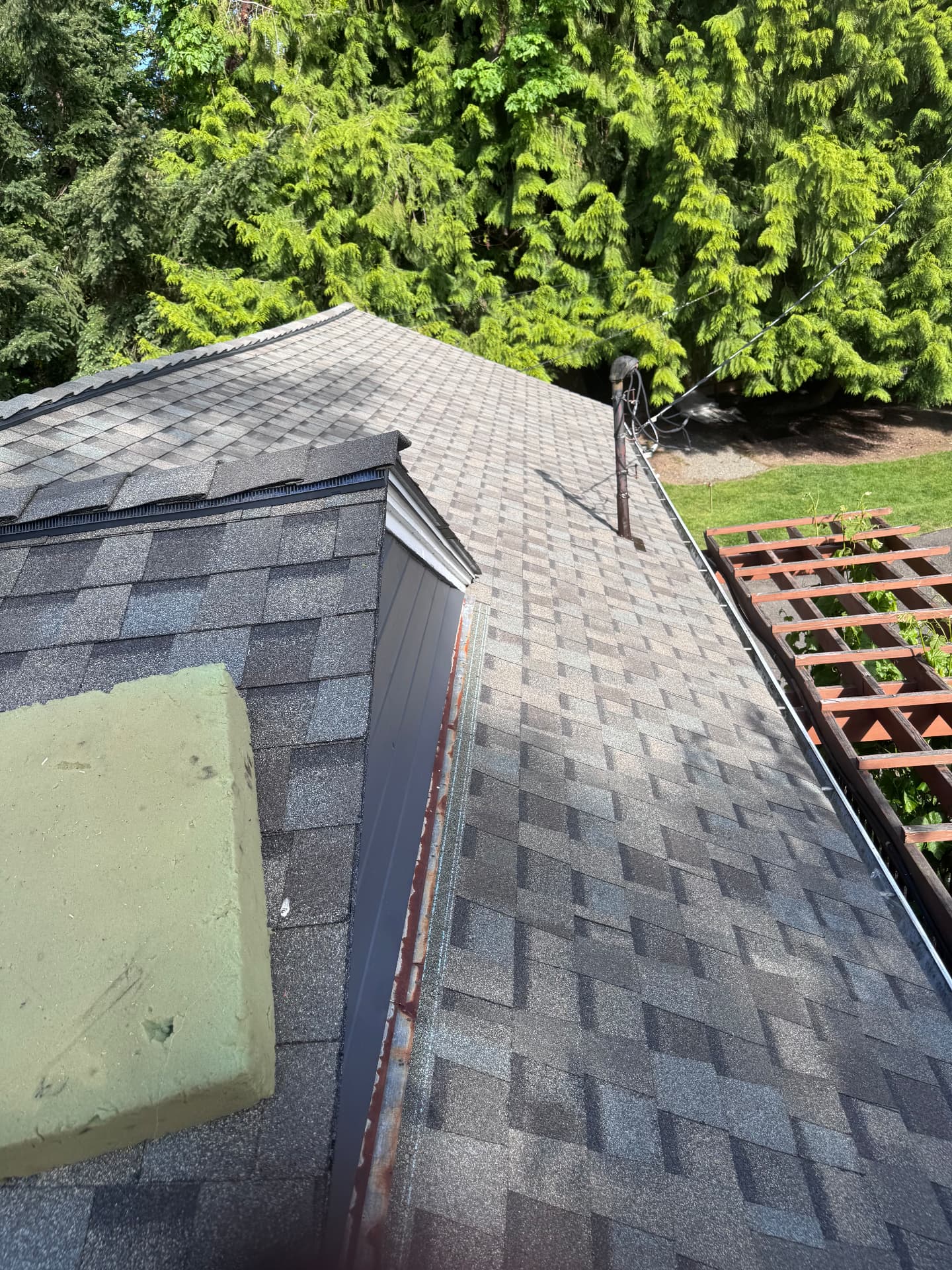 Roof ridge with new flashing detail beside a chimney
