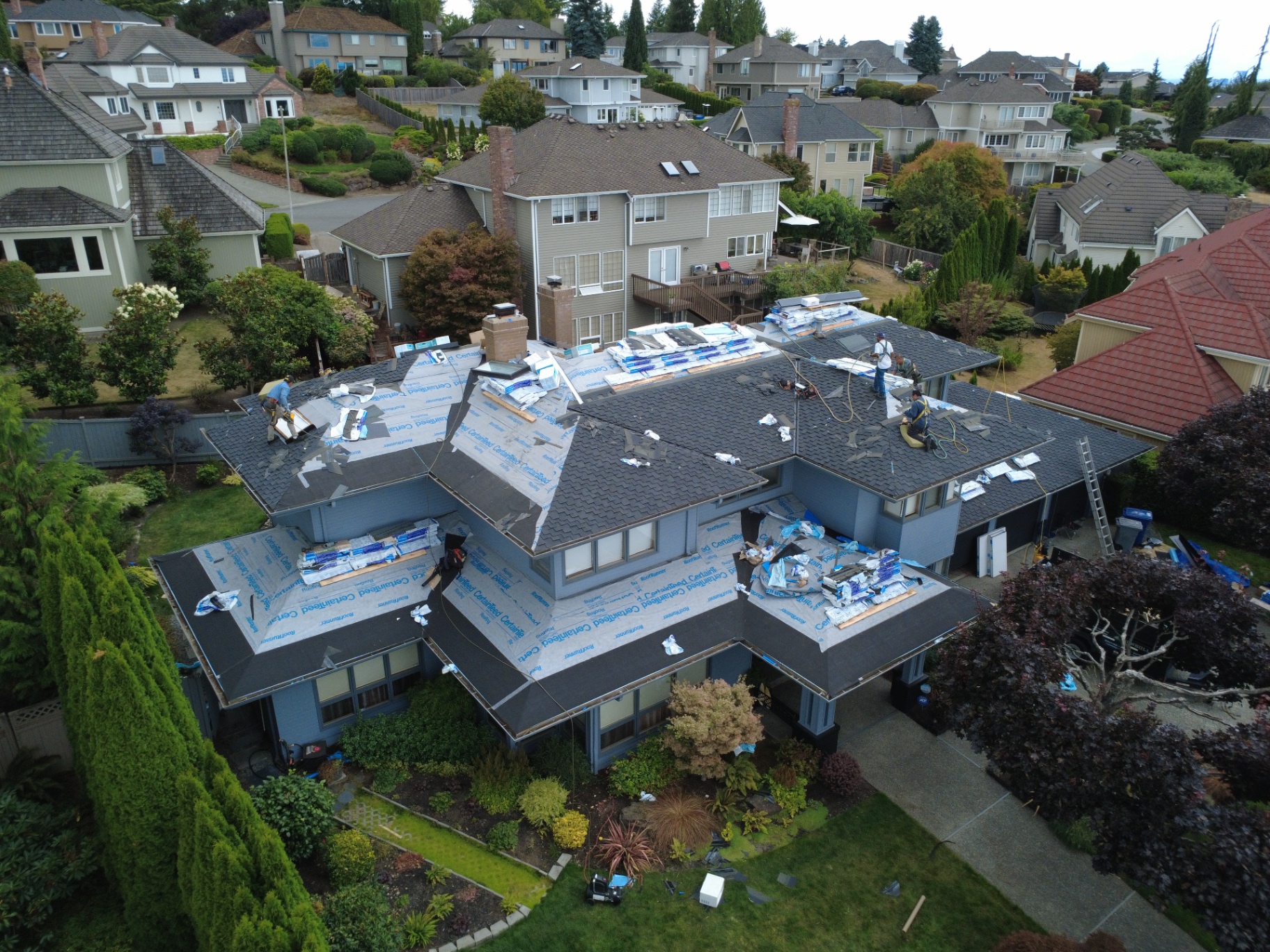Aerial view of a P.J Roofing LLC residential roof replacement in progress