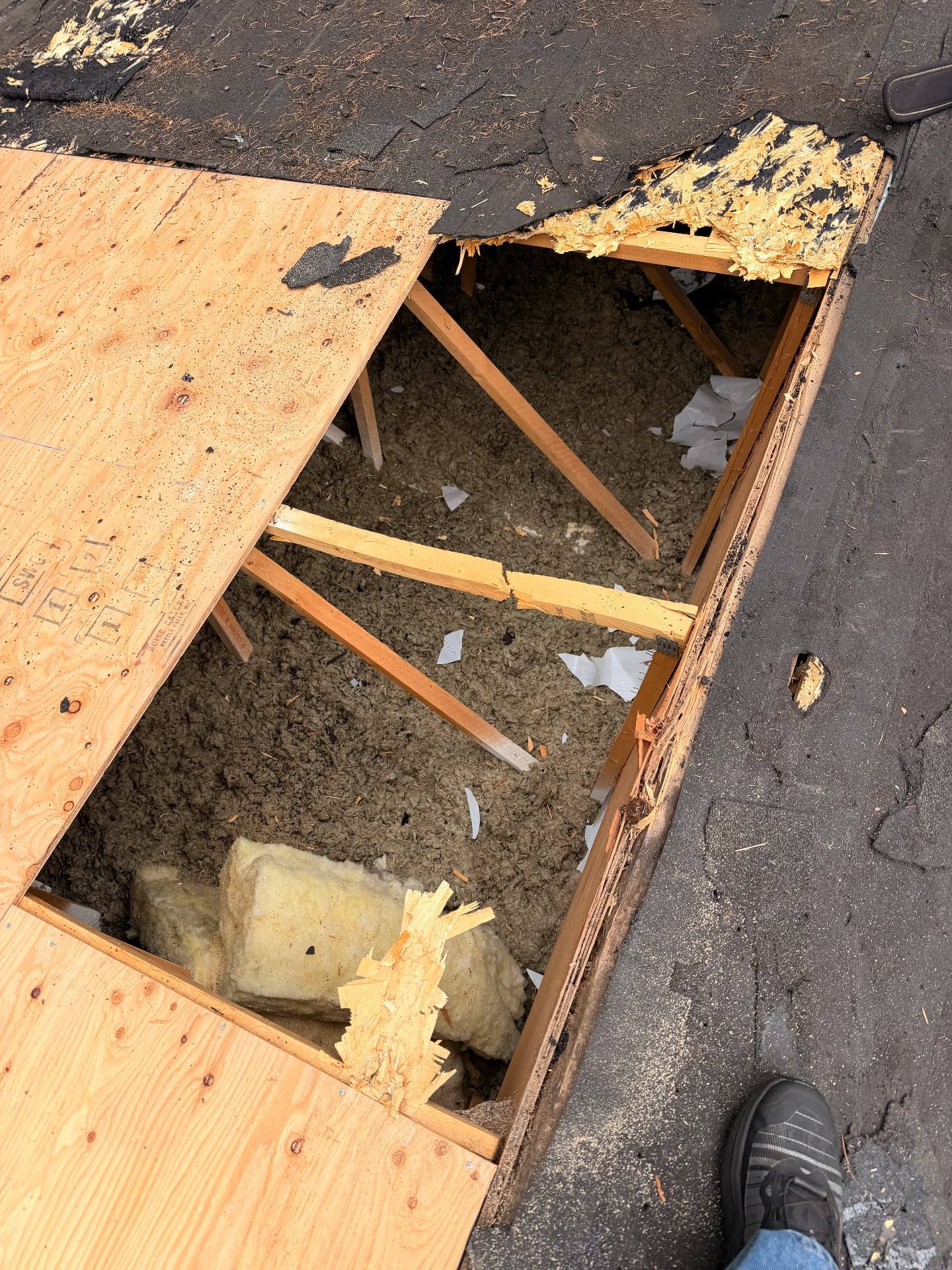 Rotted roof decking removed to expose rafters during a leak repair by P.J Roofing LLC