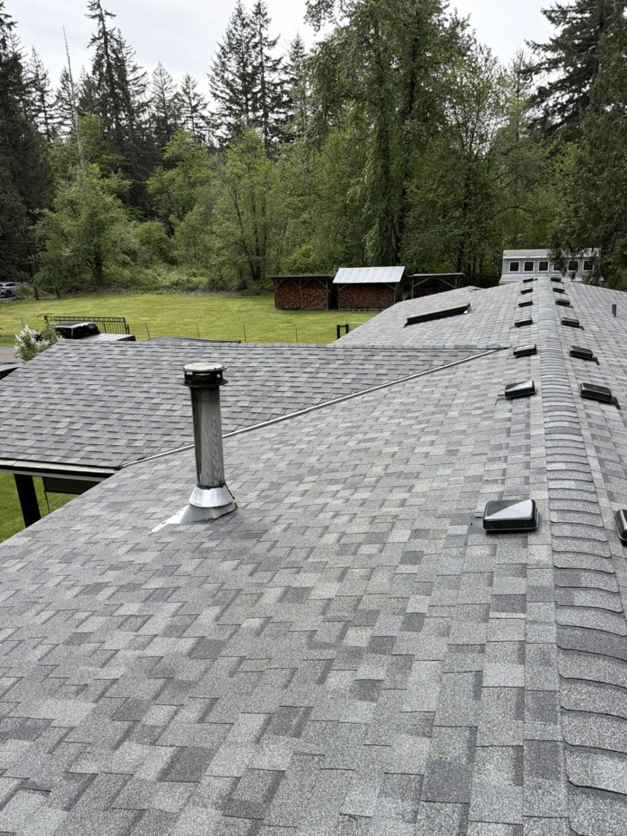 Freshly installed shingle roof with vent pipe flashing