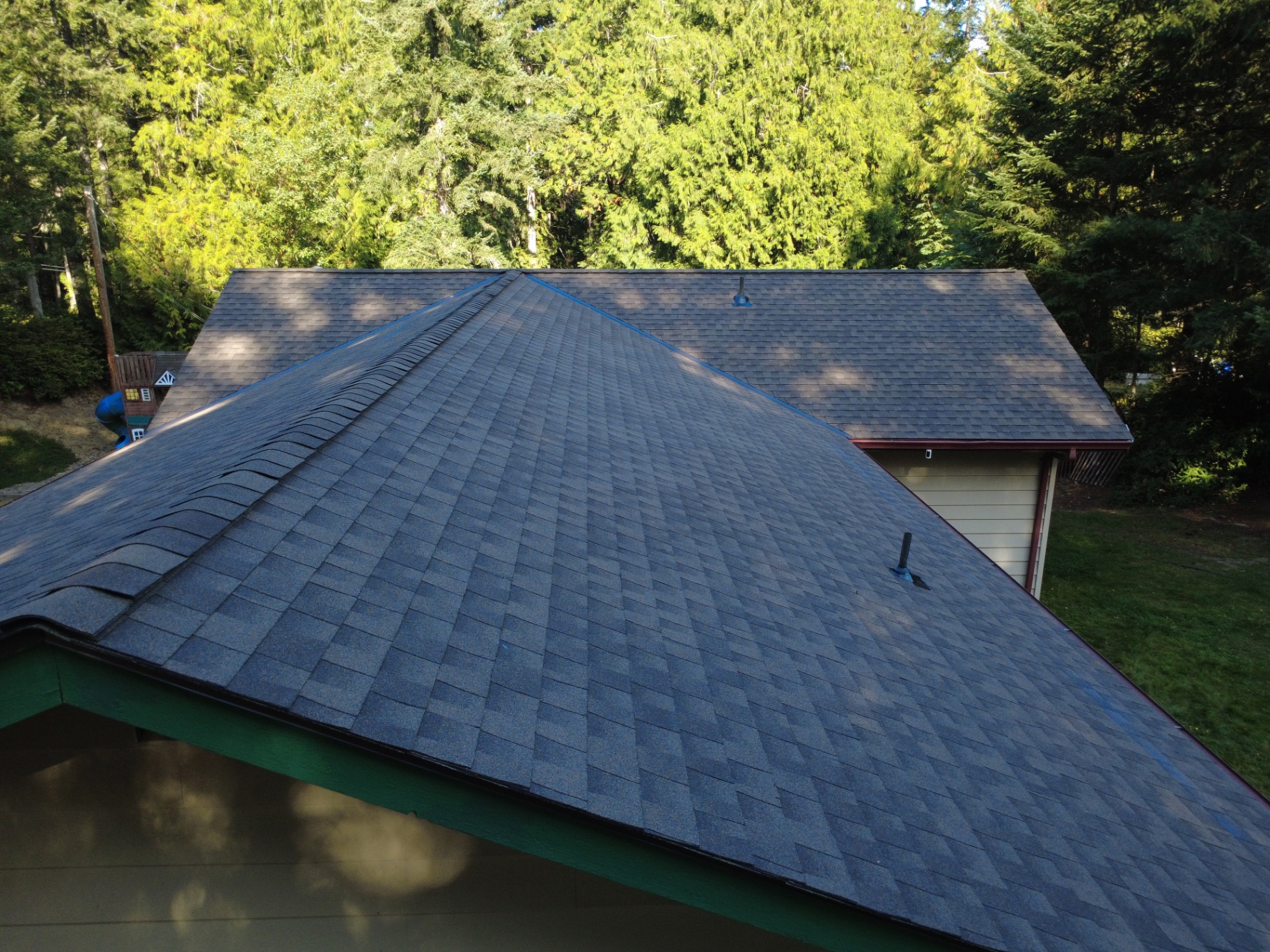 Close aerial view of new architectural shingles and ridge installation on a Silverdale home
